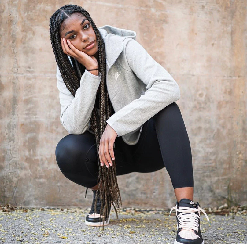 Evina Westbrook posing by a wall.